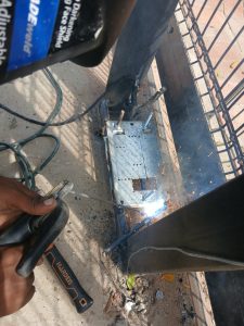 Technician welding reinforced base plate for Centurion D6 Smart installation in Wellington