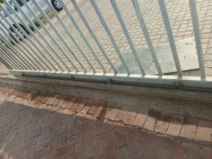 New metal rack installed and aligned on the sliding gate.